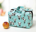 An insulated lunchbox tote with a light blue panda print and black zipper.
