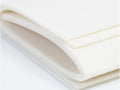 A stack of white, flexible foam sheets with rounded edges.