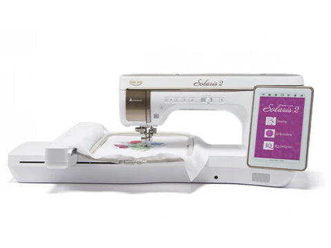 A white Baby Lock Solaris 2 sewing and embroidery machine with a colorful design on fabric.